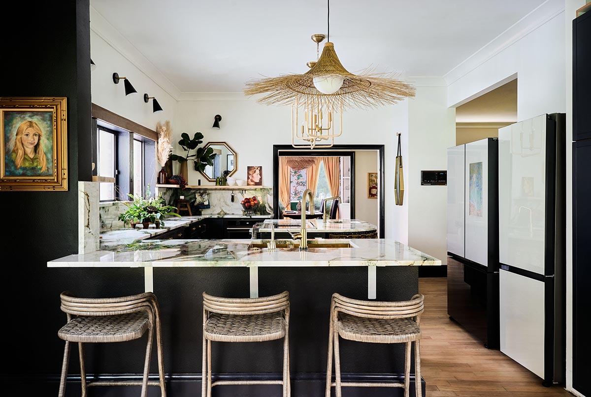 Kitchen featuring a breakfast bar with three stools